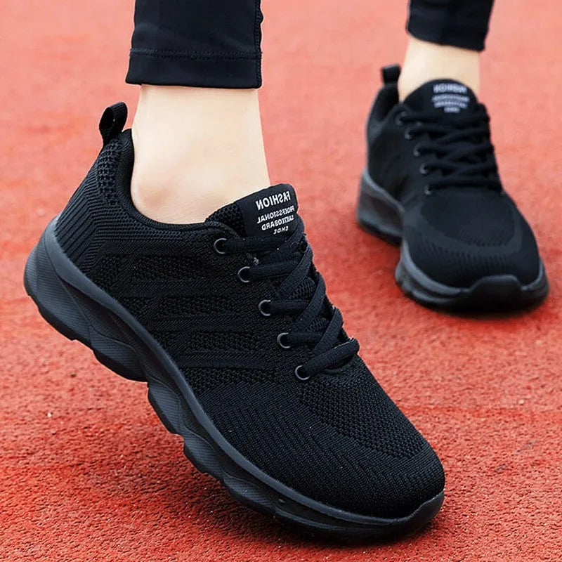 Women's white mesh breathable leisure jogging shoes with front lace-up.