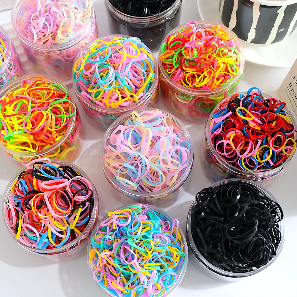 Assorted colourful TPU baby hair ties in a reusable plastic container.