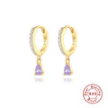 Geometric water drop sterling silver earring with a crystal stone in a gold tone setting.