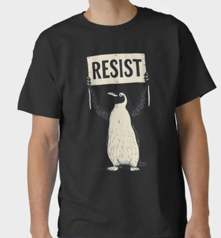 Straight-cut loose cotton T-shirt in black on a hanger, showing short sleeves and round neck.
