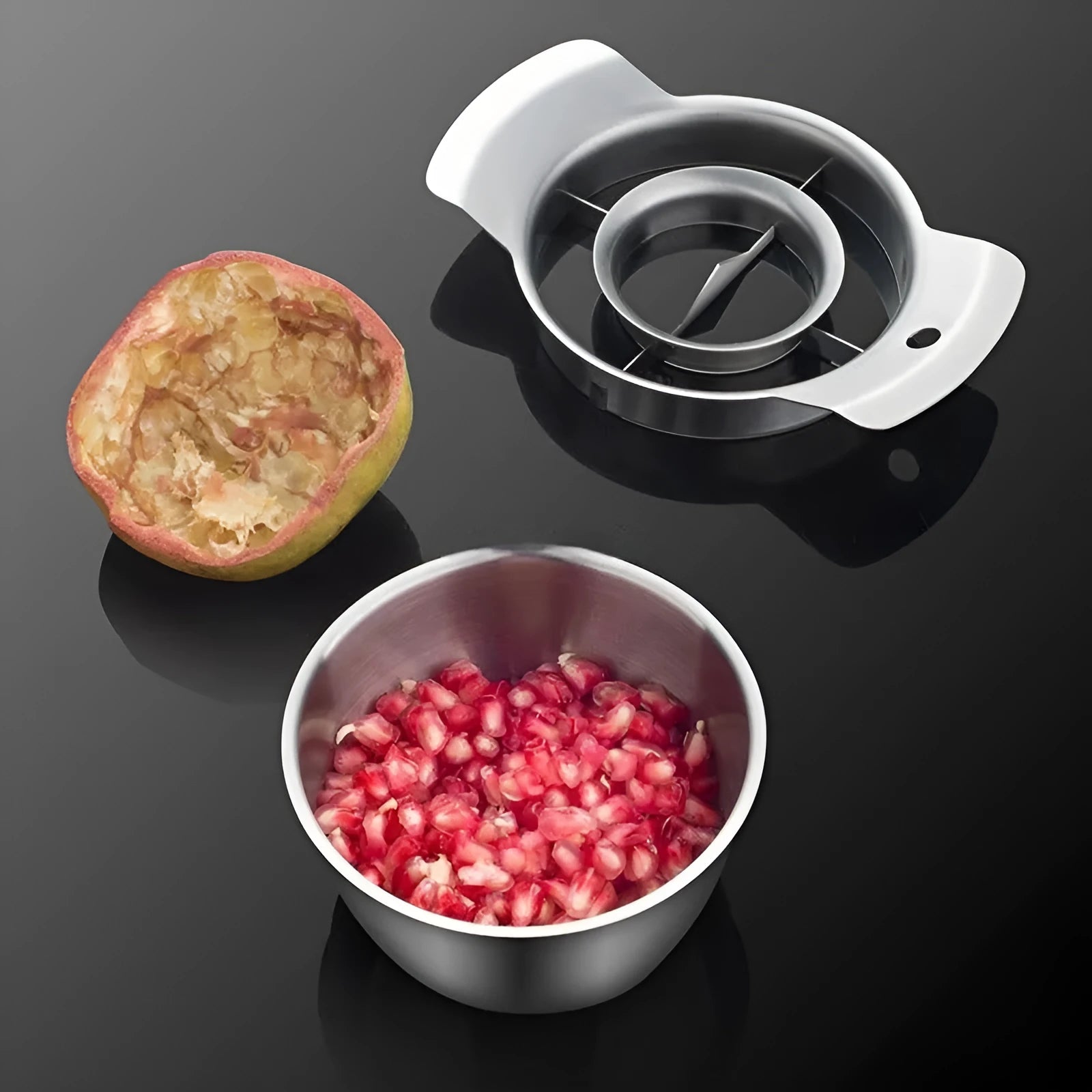 Stainless steel pomegranate fruit cutting tool set with bowl and wooden hammer on a kitchen counter