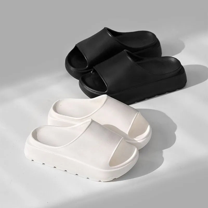 Women's beige fish mouth style slippers with a thick EVA sole on a wooden floor.