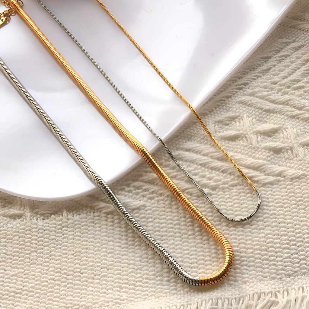 Golden 3mm thick stainless steel snake bone chain necklace for women.
