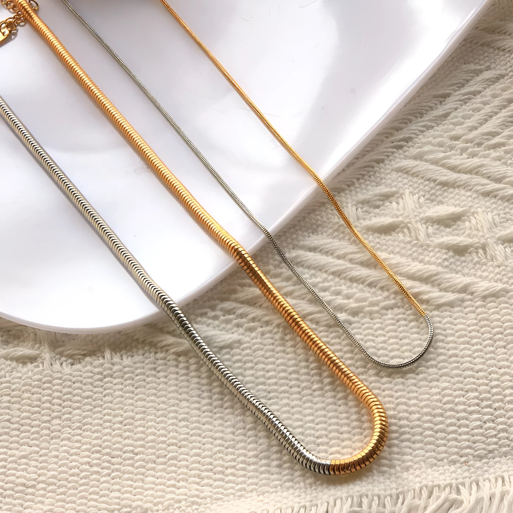 Golden 3mm thick stainless steel snake bone chain necklace for women.