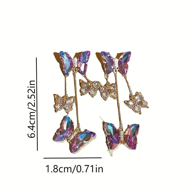 Blue purple butterfly-shaped drop earrings with crystal flowers and a metal tassel.