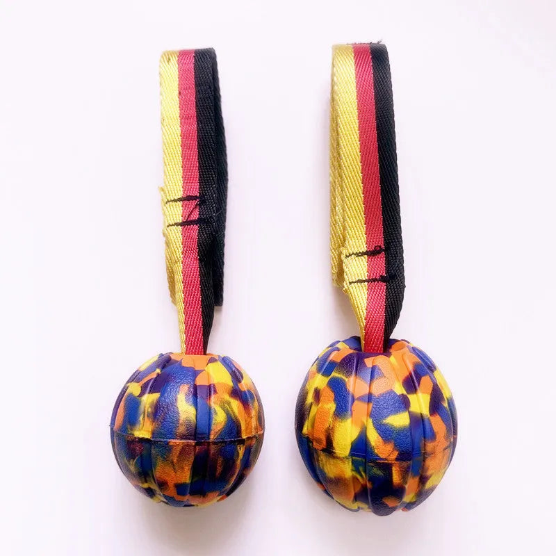 Floating EVA foam dog training ball with string in camouflage or yellow colour, shown in 6.5cm, 7cm, and 9cm diameter sizes