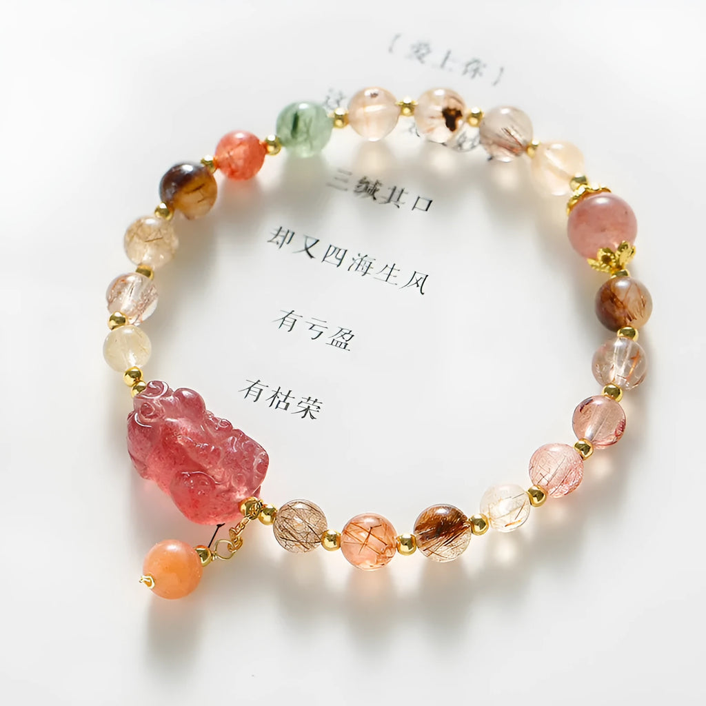 Women's copper bracelet with strawberry quartz crystal, Pixiu charm, and pearl beads.