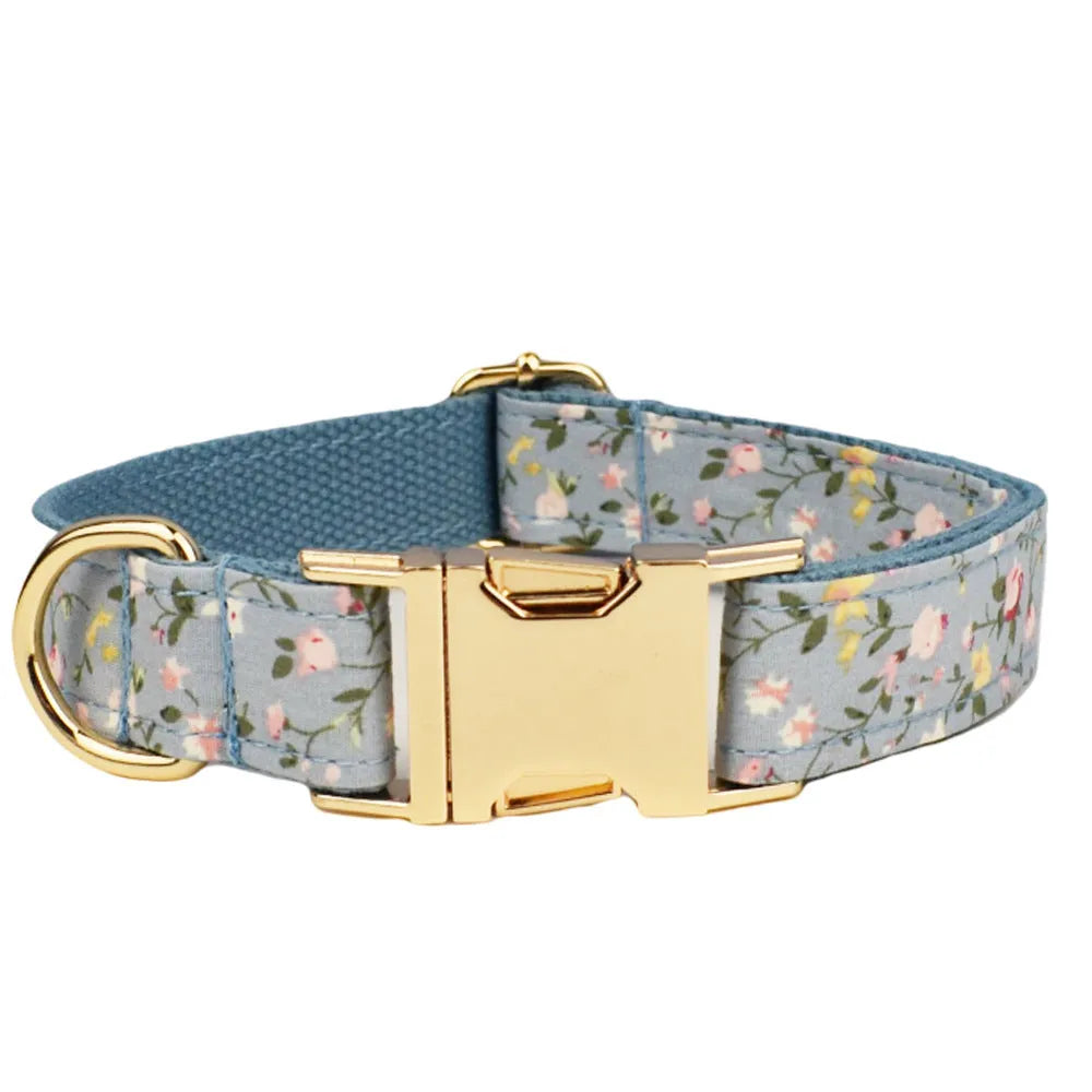 Blue floral cloth dog collar and leash set with bow and vest accessories on a size chart from XS to XL.