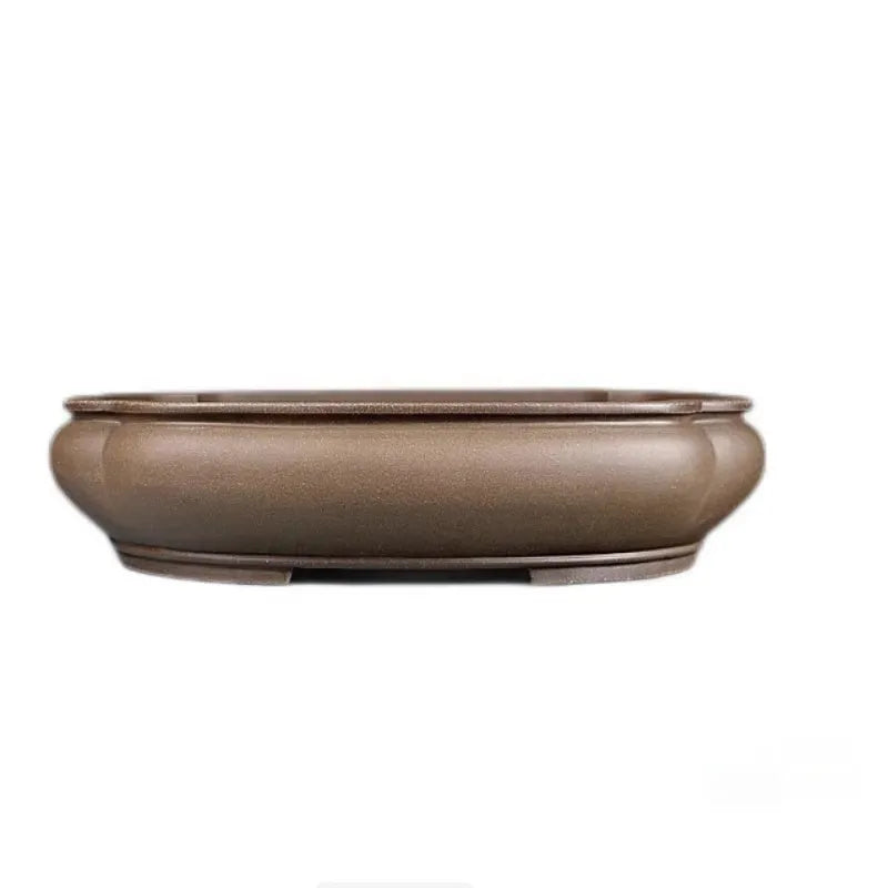 Handmade antique purple clay papaya-shaped flower pot on a table.