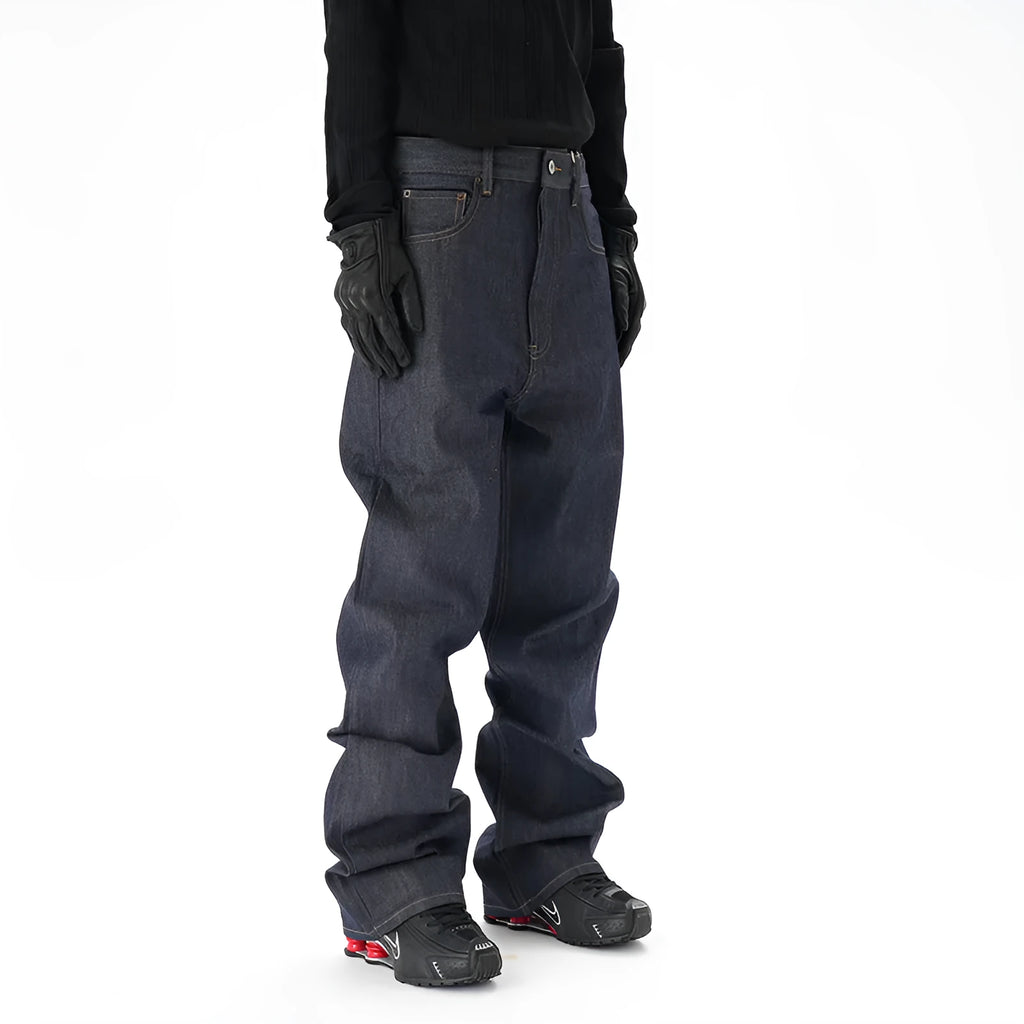 A pair of dark blue loose straight-cut jeans laid flat, showing the front design.