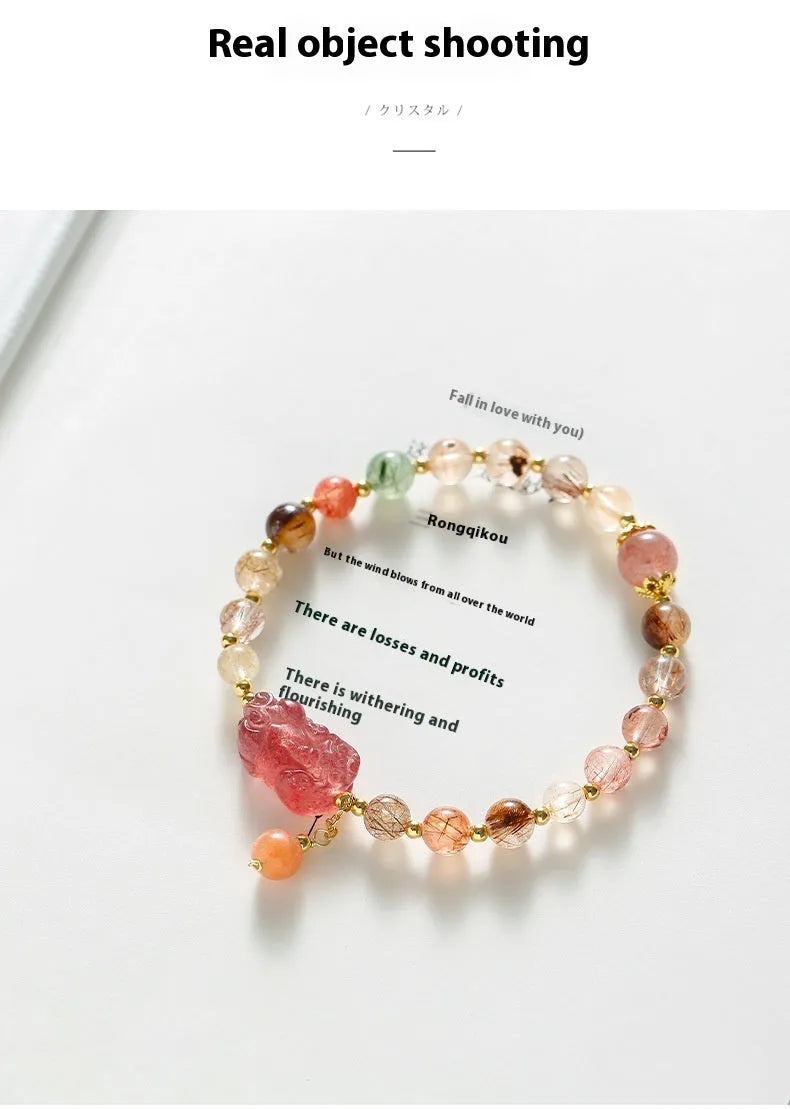 Women's copper bracelet with strawberry quartz crystal, Pixiu charm, and pearl beads.