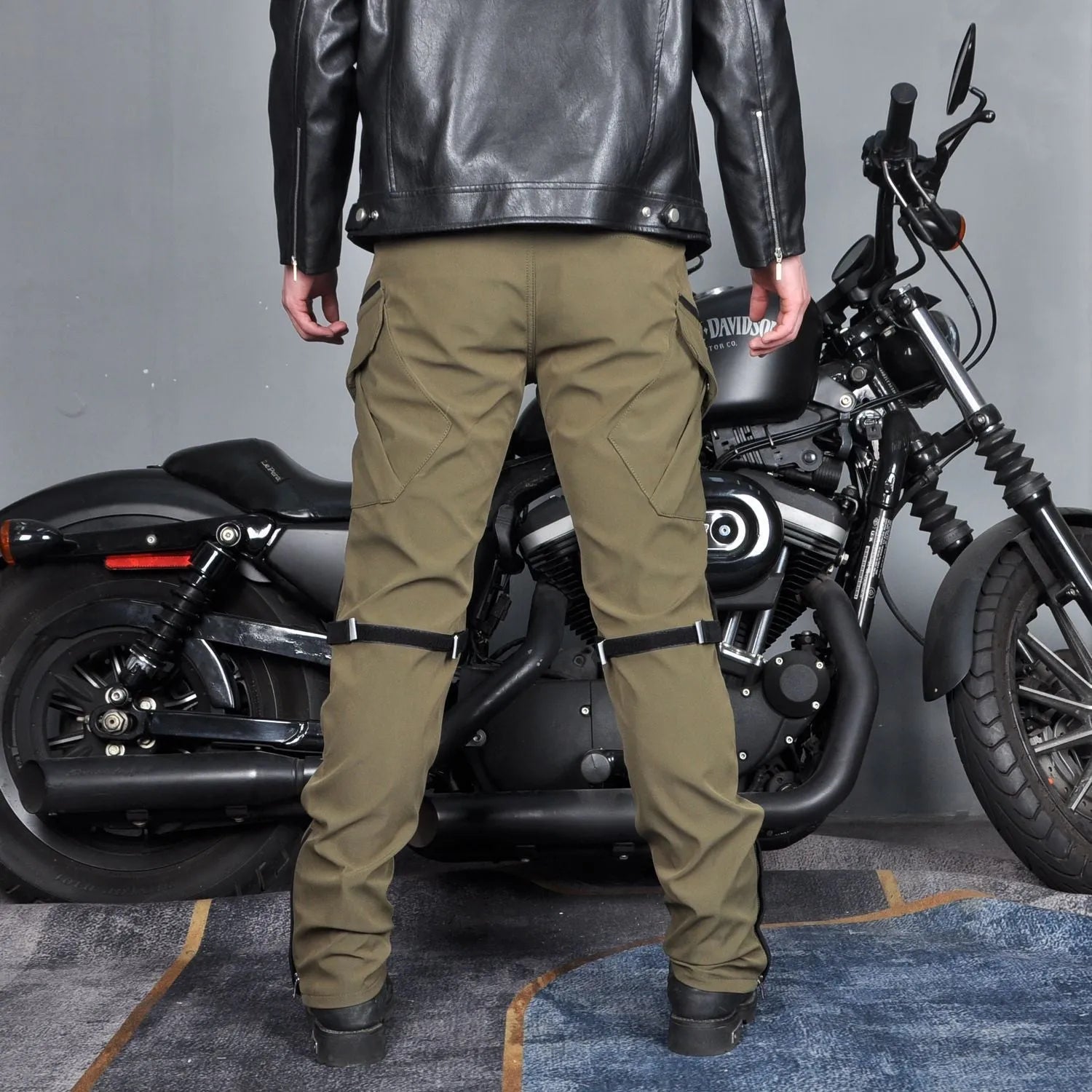 Men's solid-colour waterproof motorcycle trousers shown with a detachable belt and protective knee pads.