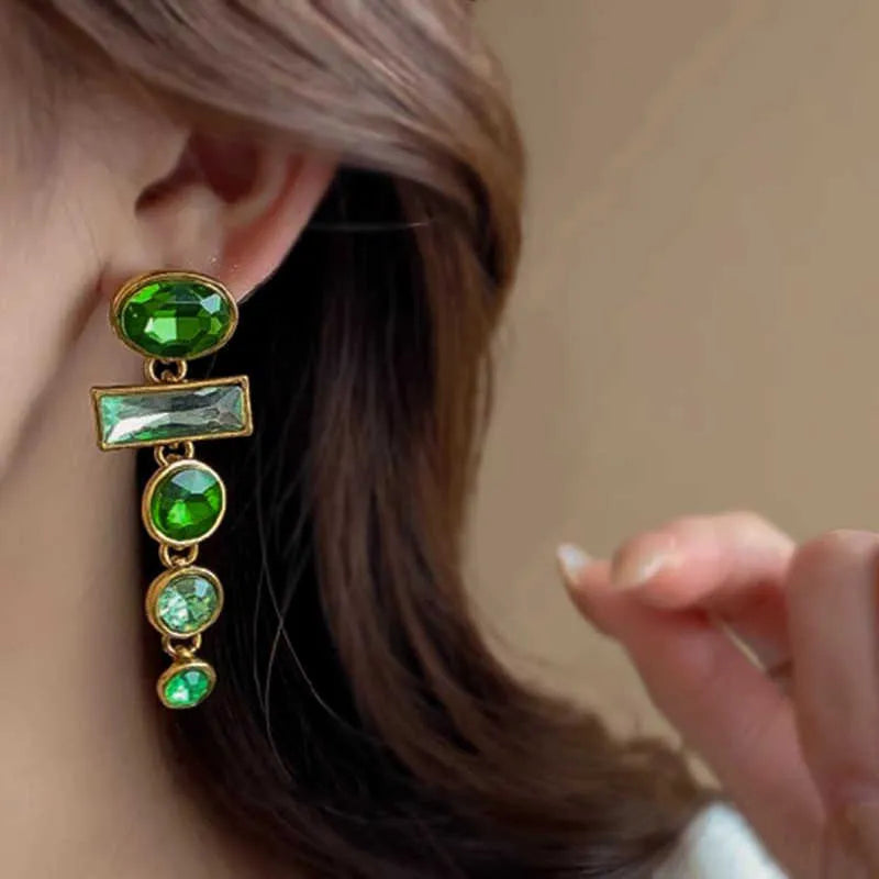 A pair of green gradient tassel earrings with a geometric shape and inlaid zircon detail.