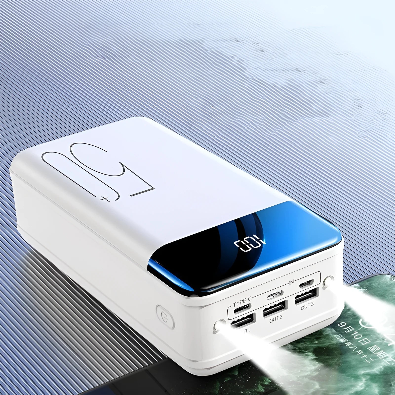 Black and white large capacity 50000mAh power bank with three USB output ports.