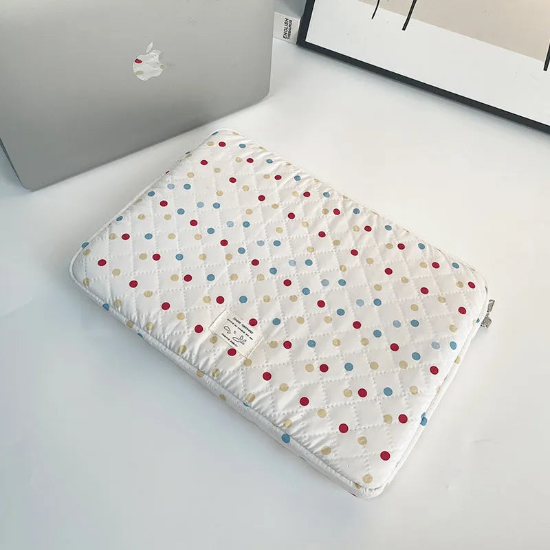 Women's polka dot polyester laptop bag shown in solid colour with size options for 11-inch to 15.6-inch laptops.