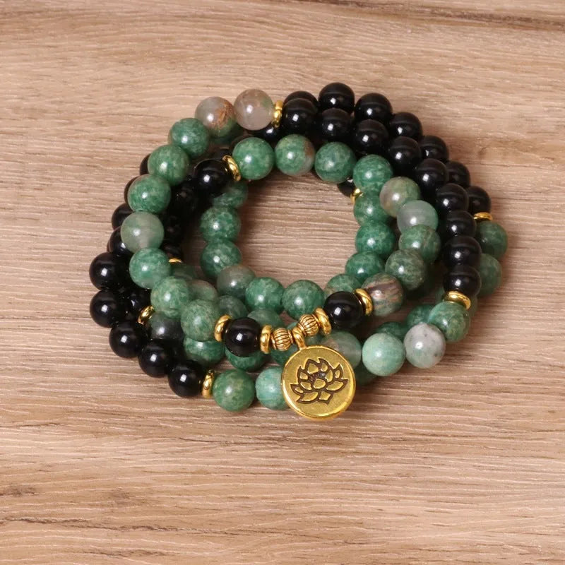 Long elastic bracelet with green and black alloy charms and natural style beads on a stretch band.