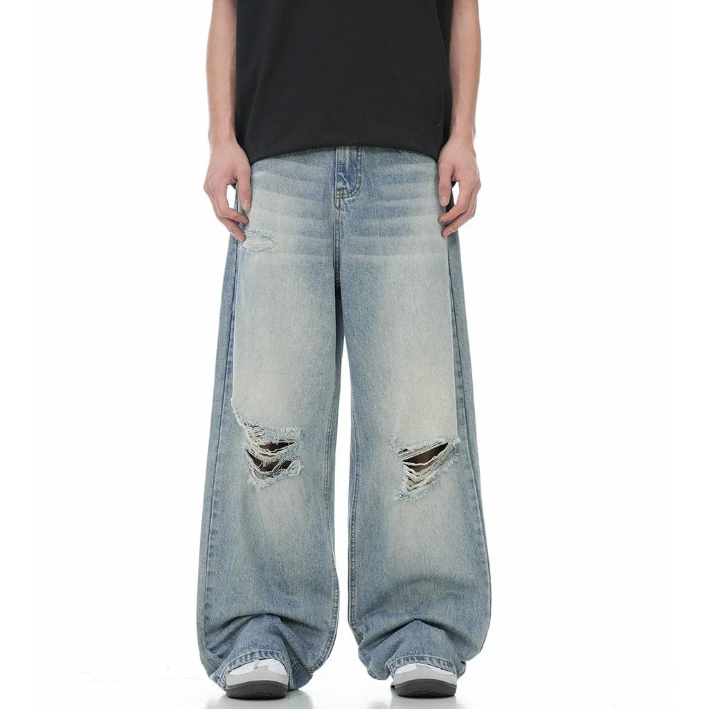 Blue straight-leg jeans with ripped detailing on cotton blend fabric