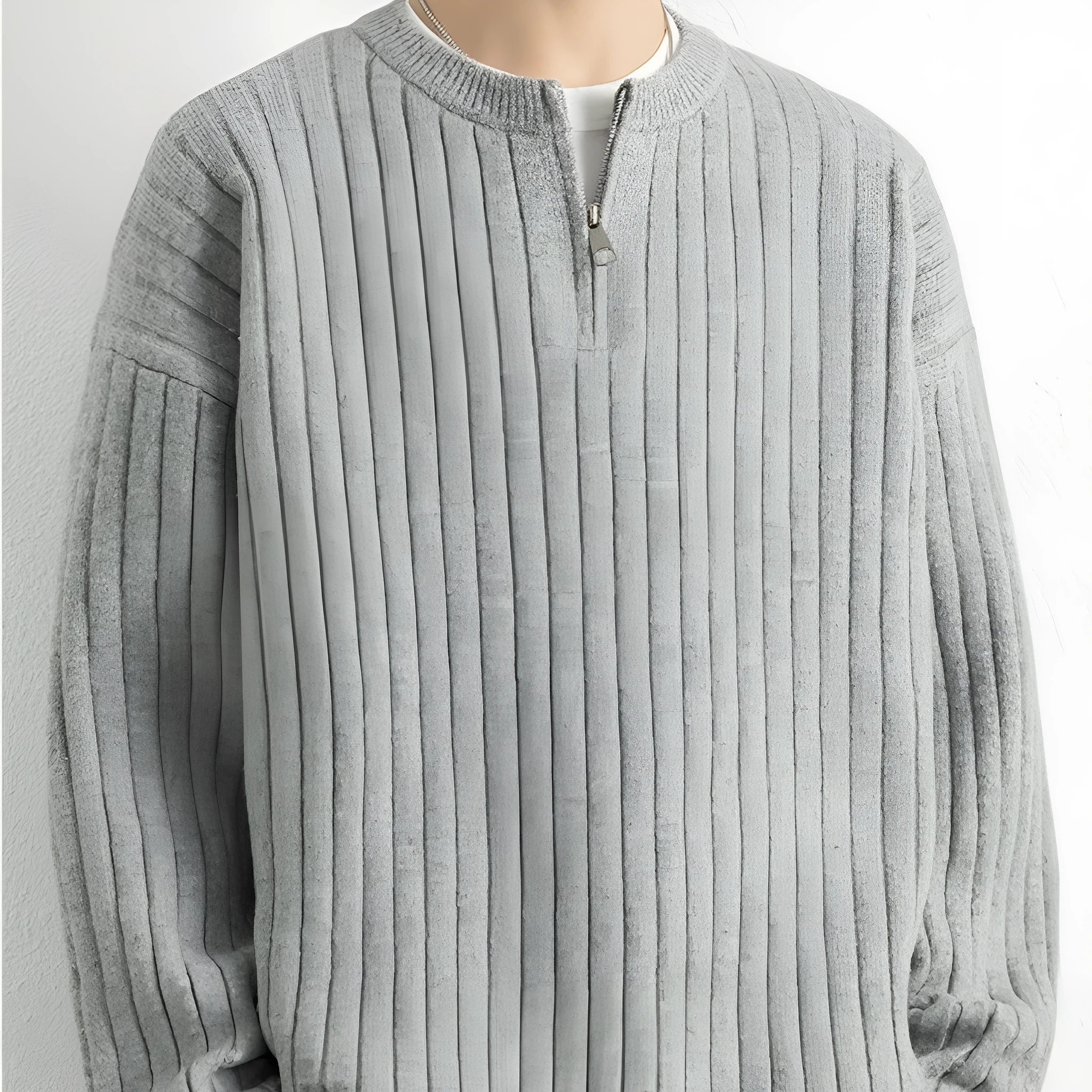A grey men's loose fit half zip pullover sweater with a textured knit and long sleeves.