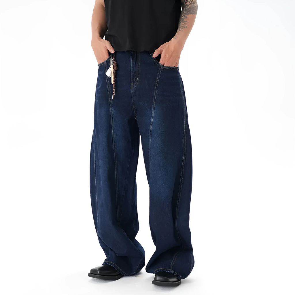 Dark blue wide-leg jeans with a distressed wash on a denim fabric, showing a relaxed fit.