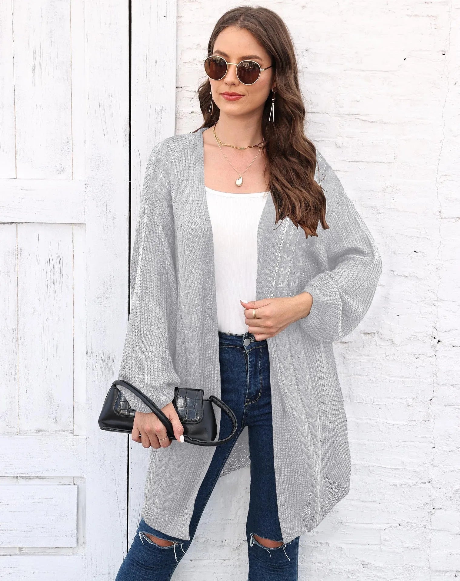 Women's loose-fitting solid colour acrylic sweater coat on a hanger