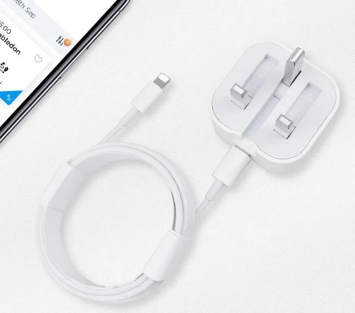 White 20W USB-C Power Delivery fast charger with British plug and coiled USB-C cable.