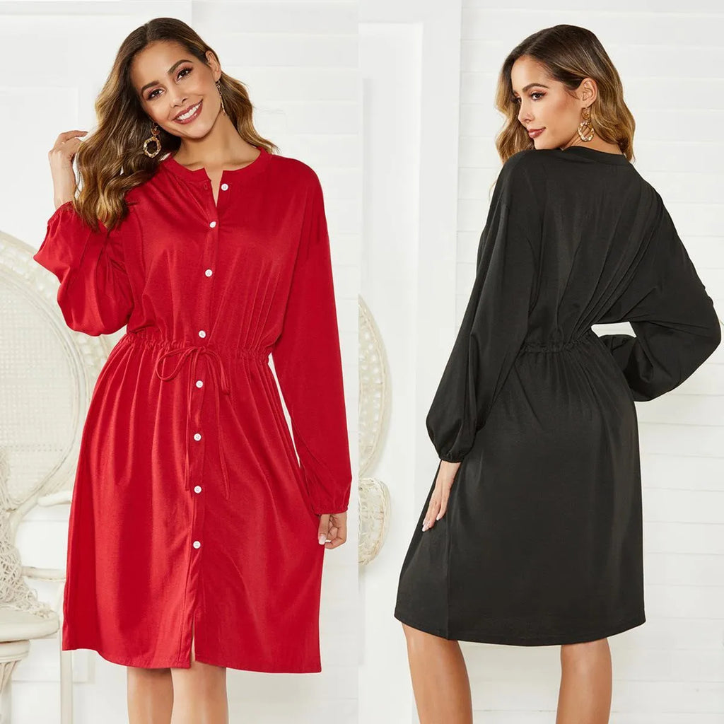 Black A-line midi dress with long sleeves, elastic cuffs, and a belt at the elastic waist.