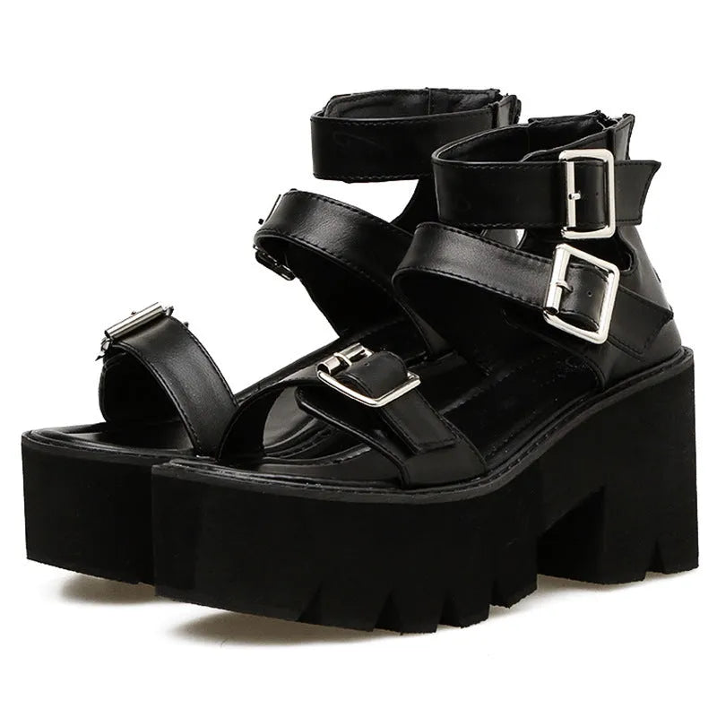Black punk-style women's sandals with a thick chunky heel, round toe, buckle detail and back zipper.