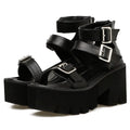Black punk-style women's sandals with a thick chunky heel, round toe, buckle detail and back zipper.