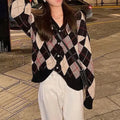 A knitted casual cardigan coat in a macaron colour, shown on a hanger with regular sleeves.