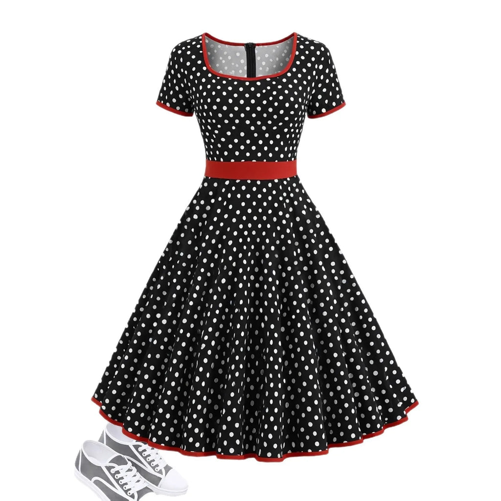 A women's polka dot pleated dress with a square collar and zip closure.