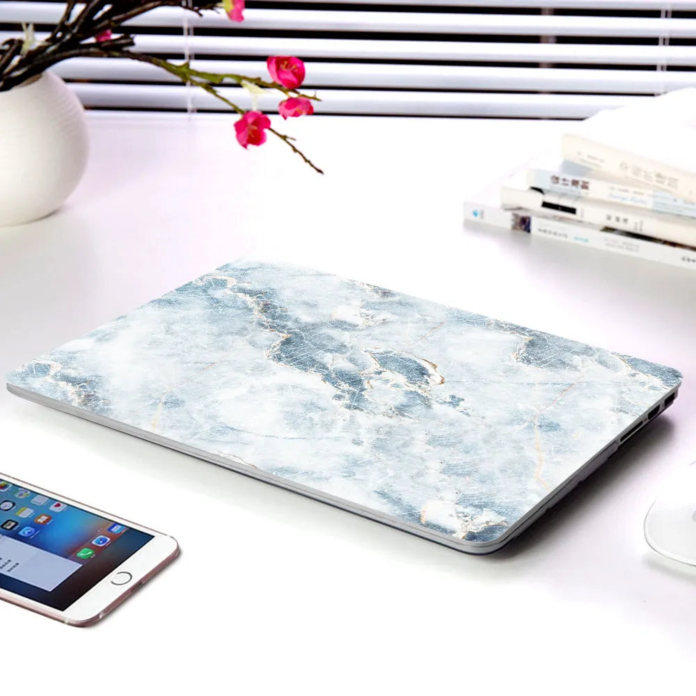 Plastic marble finish protective case for a MacBook laptop in light blue colour.