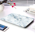 Plastic marble finish protective case for a MacBook laptop in light blue colour.