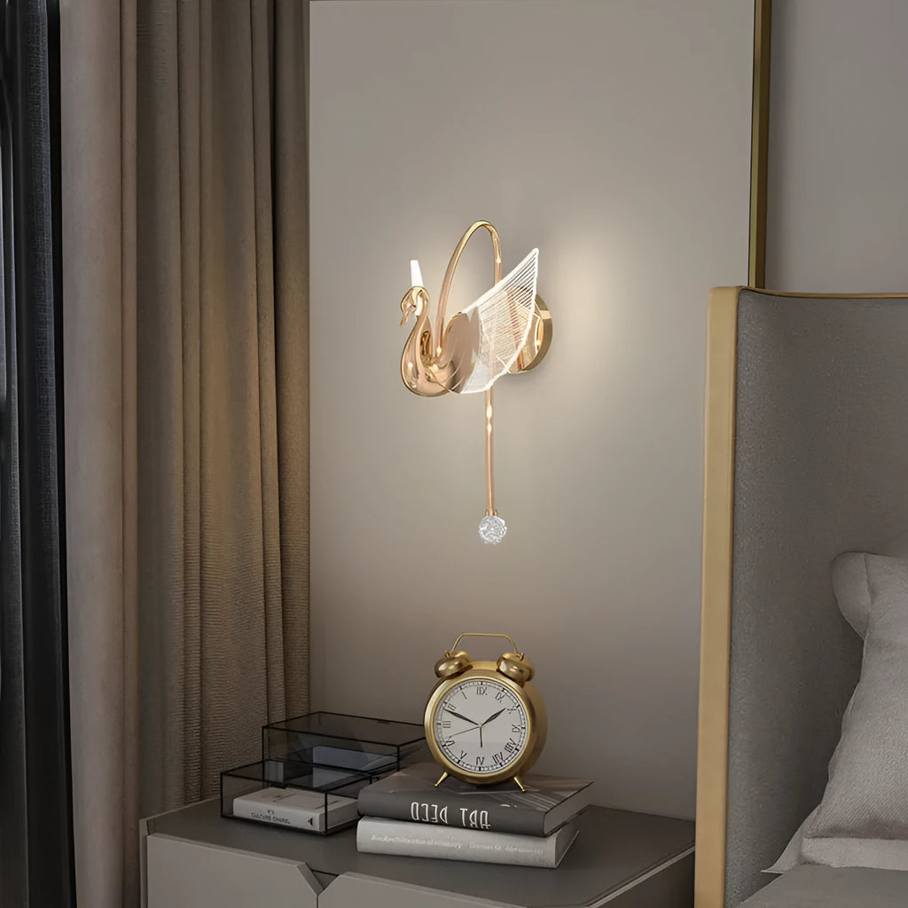 Gold modern swan-shaped wall lamp with an acrylic shade and dimmable LED light.