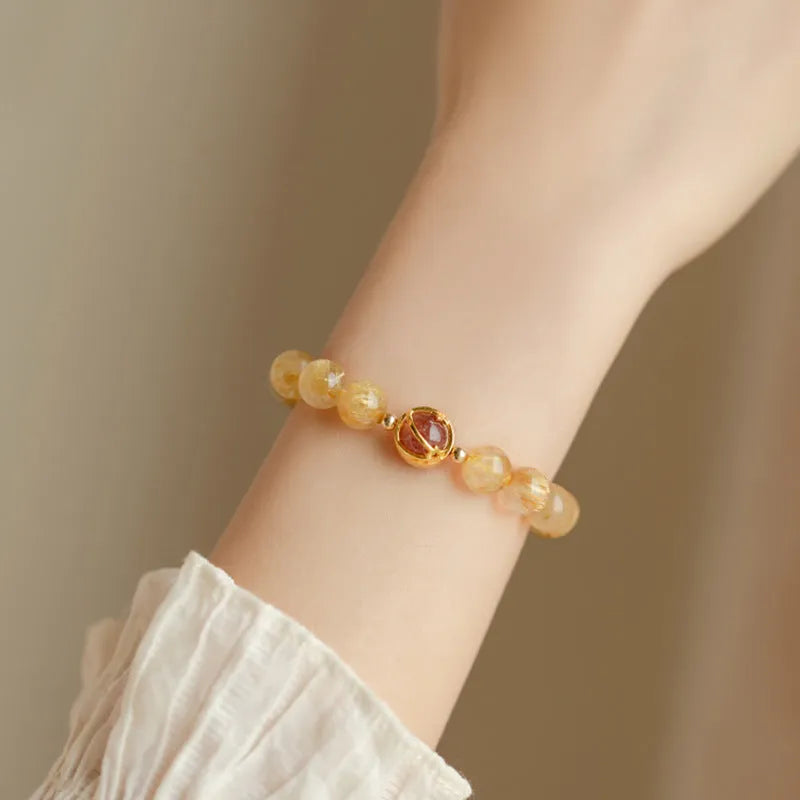 Gold rutilated quartz crystal bracelet with diamond-cut beads in 6mm and 8mm size options.