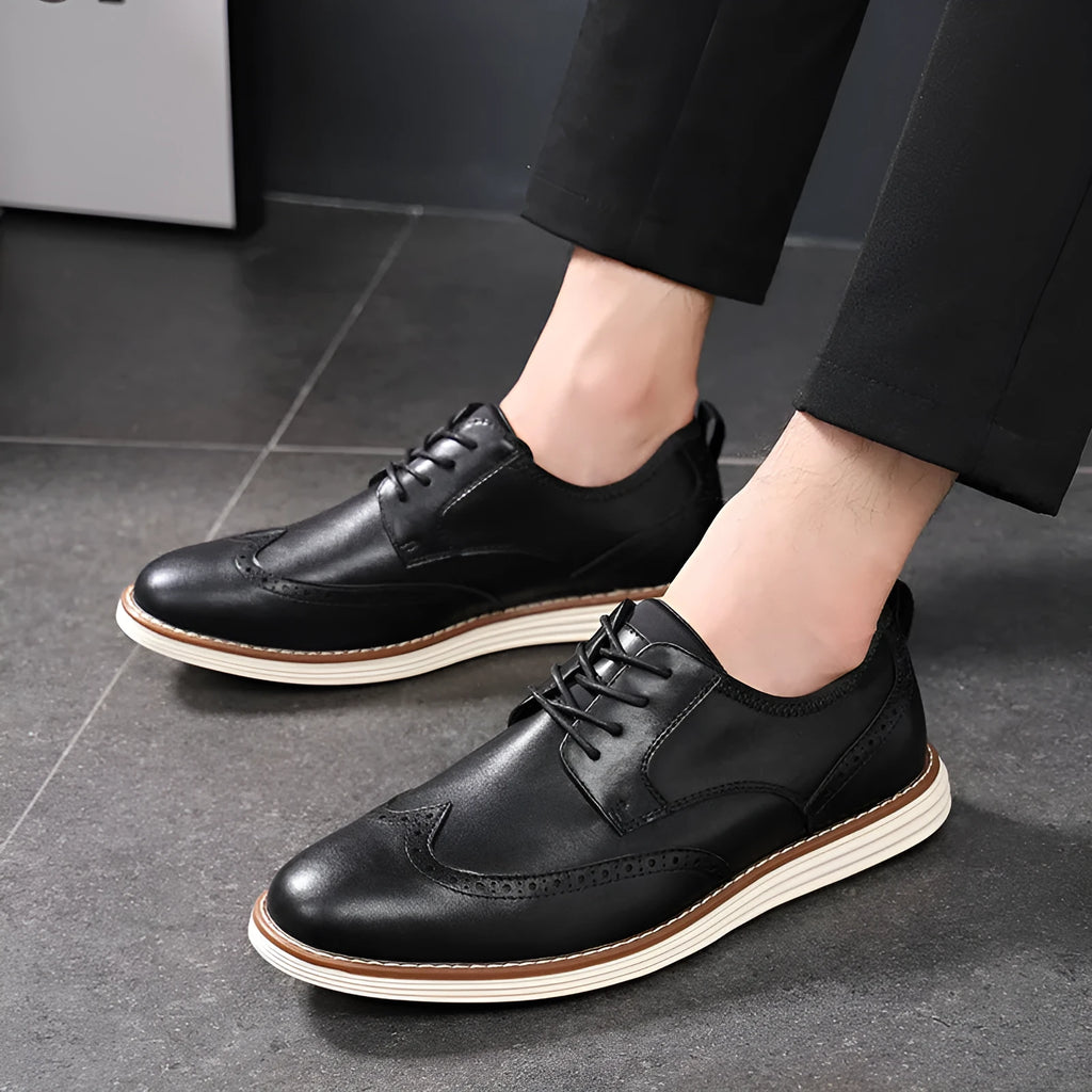 Men's black slip-on casual shoe with PU leather upper and round toe on a grey background.