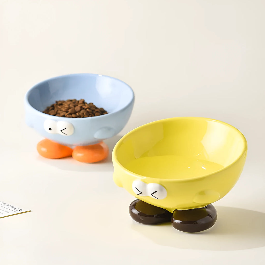 Blue slanted ceramic pet bowl with cute expression design for cat and dog cervical spine support