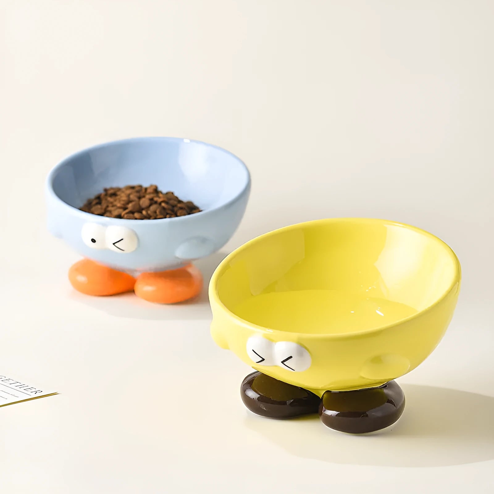 Blue slanted ceramic pet bowl with cute expression design for cat and dog cervical spine support