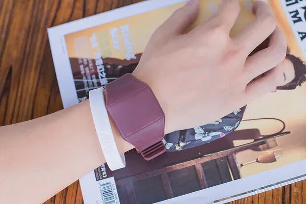 Square electronic touch screen watch showing numeric display on a coloured PU strap.