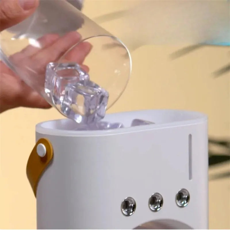 White double-ended portable USB fan with humidifying spray tank and remote control on a desk.