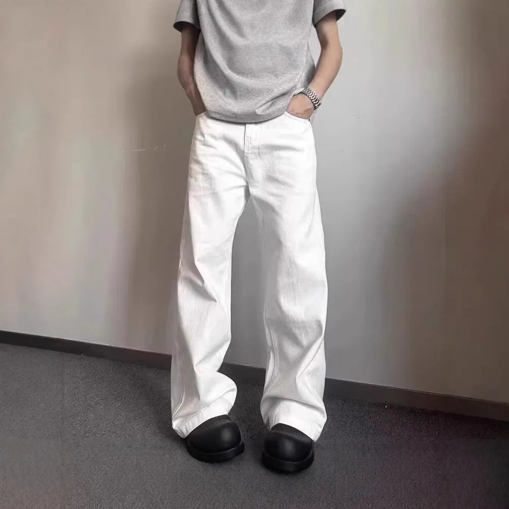 Men's white straight wide-leg denim jeans on a mid waist, showing zipper fly and relaxed fit.