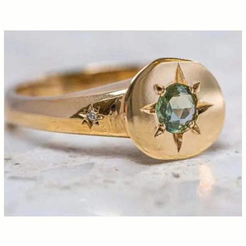 Gold coloured adjustable star ring with oval asterism zirconia stone.