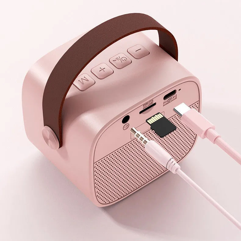 Portable Bluetooth speaker with microphone in white, pink or blue colours showing compact 8x6.5x7cm size