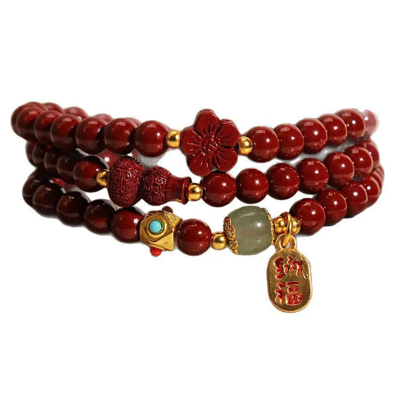 Red cinnabar bracelet with 6mm beads showing multi-circle gourd and five petal flower geometric design