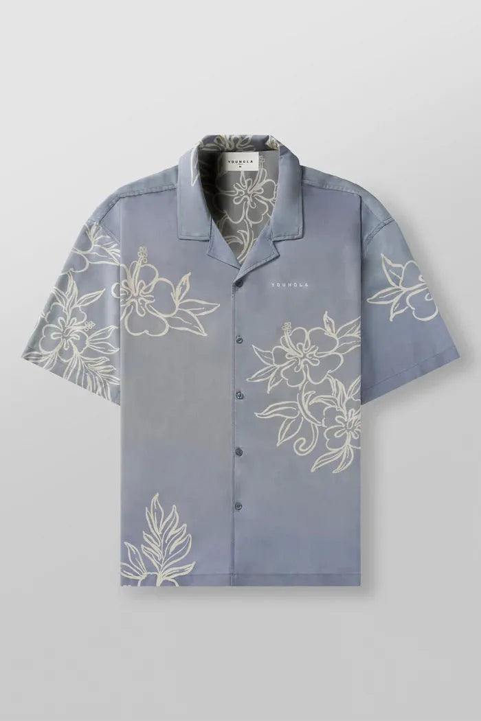 A loose-fitting short sleeve top with a floral print in a light colour, laid flat.