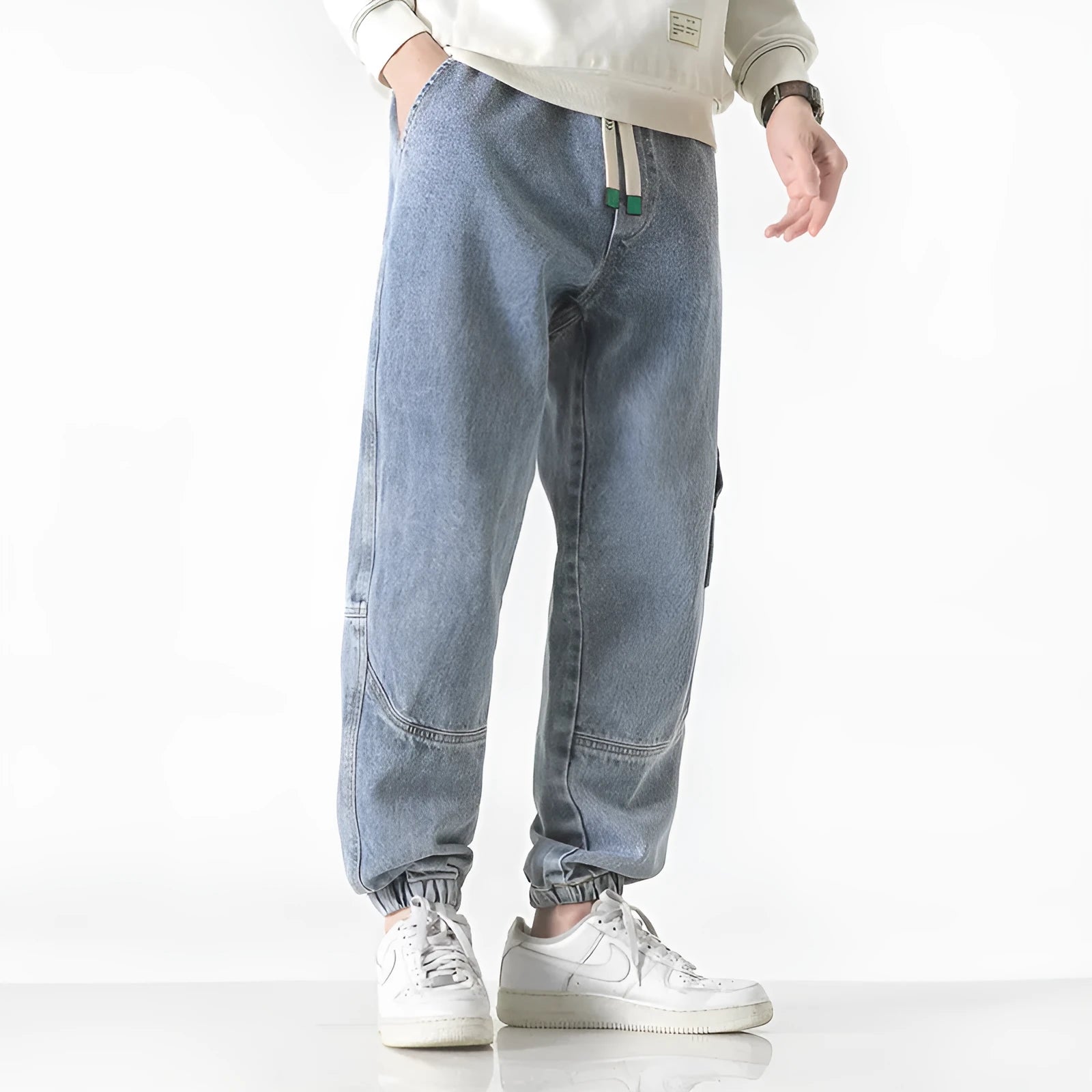 Men's loose-fit tapered cotton trousers in black, blue, and grey colours with mid waist design