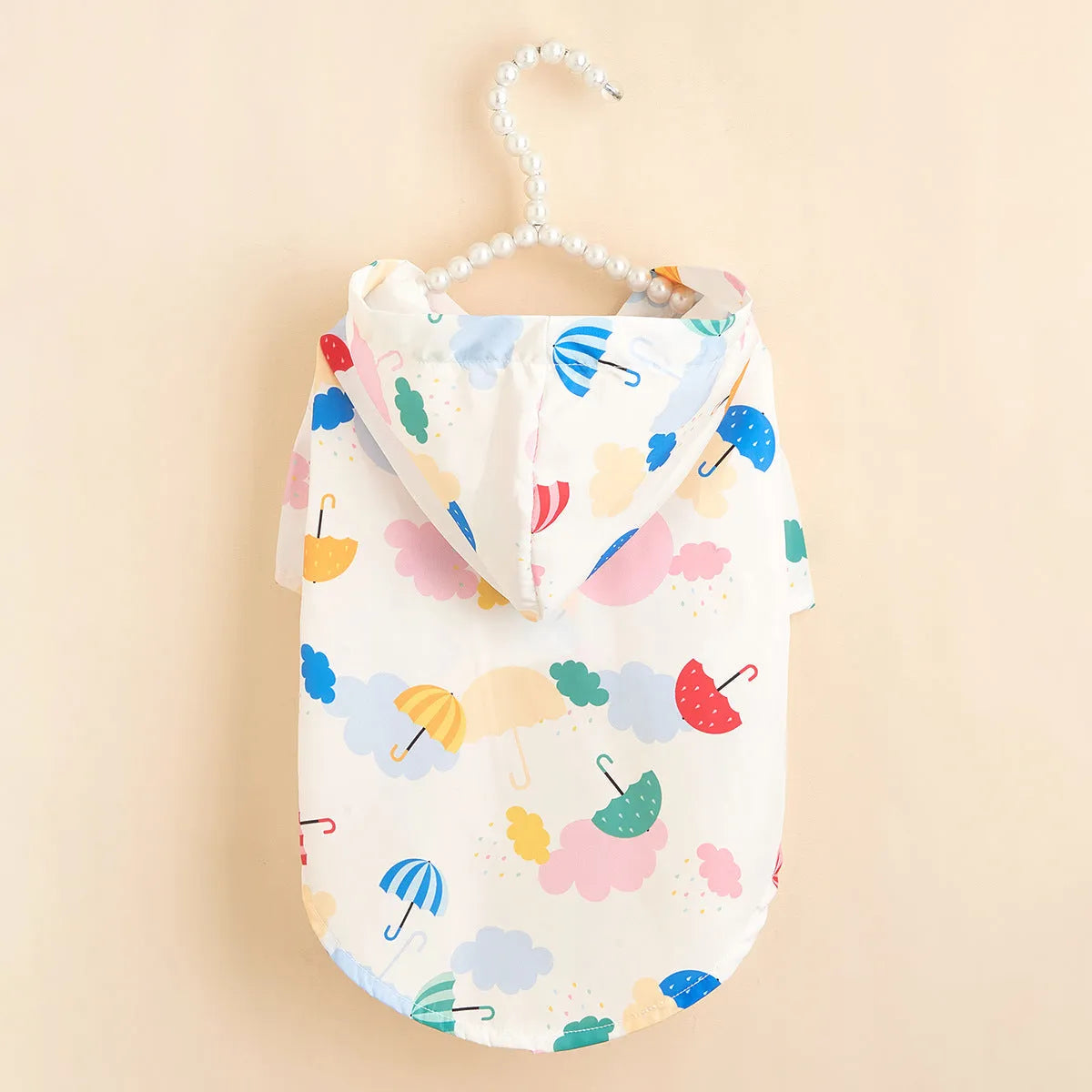 Colourful pet raincoat with a cartoon umbrella pattern, shown in size L for a medium dog.