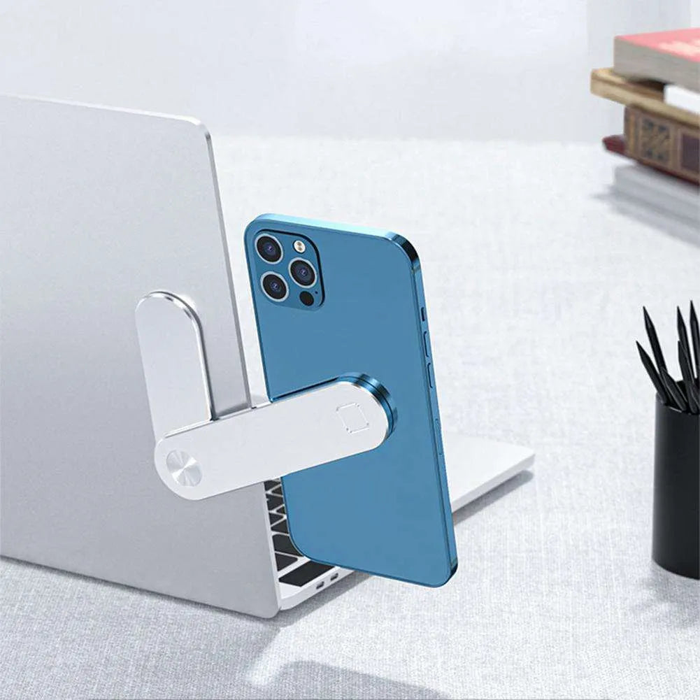 Black aluminium laptop phone holder with magnetic clip attached to a monitor, holding a smartphone