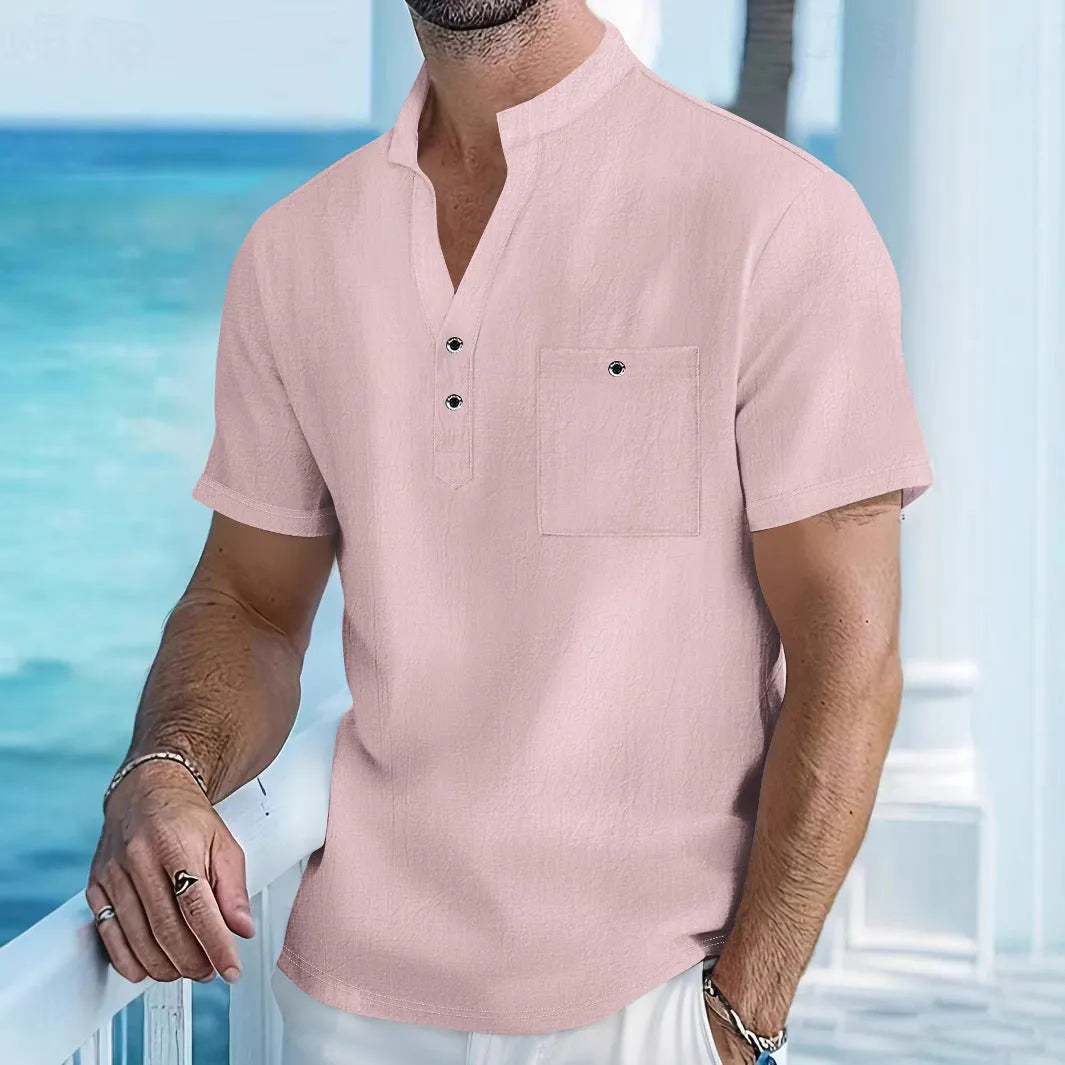 Man wearing a light apricot-coloured linen stand collar short sleeve shirt with a loose fit.