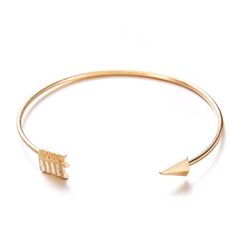 Gold vintage cuff bracelet for women with an arrow design and knotted detail.
