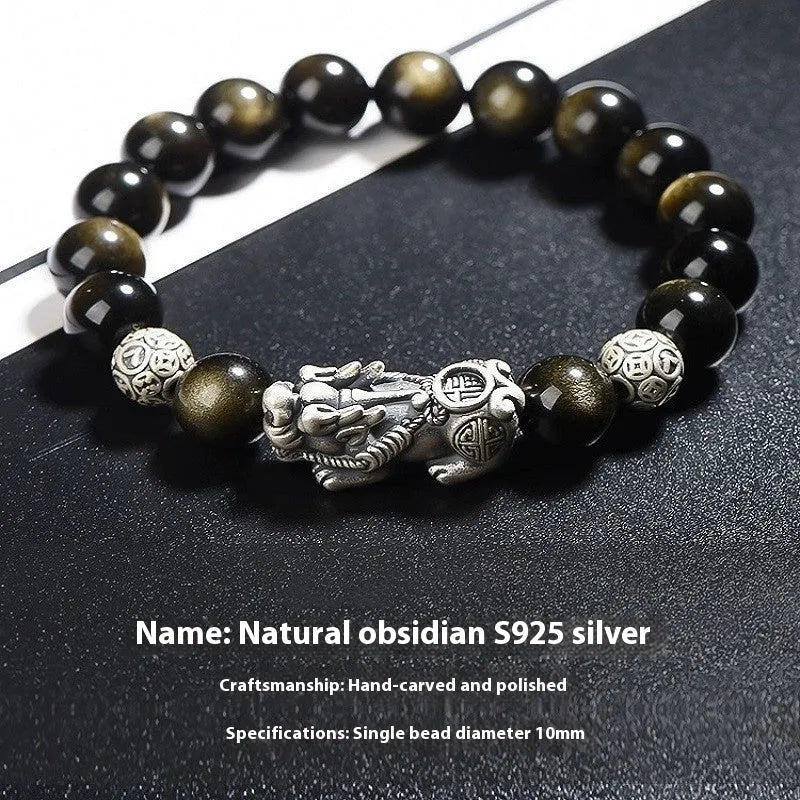 Men's geometric bracelet with obsidian stone set in 999 sterling silver on a wrist.
